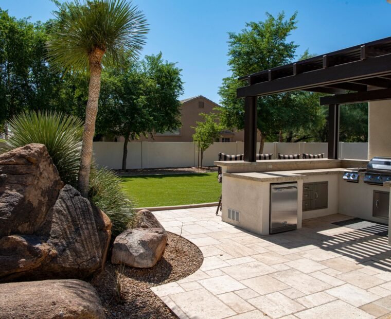 Paver patio with seating overlooking a mature lawn